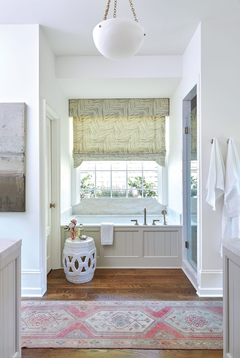 Builtin bathtub with paneling. Flanked buy linen closet and shower.