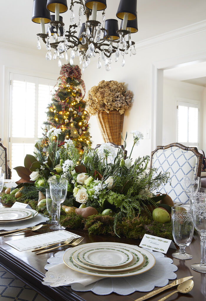 The dining room is styled with traditional green, white, and god accents.