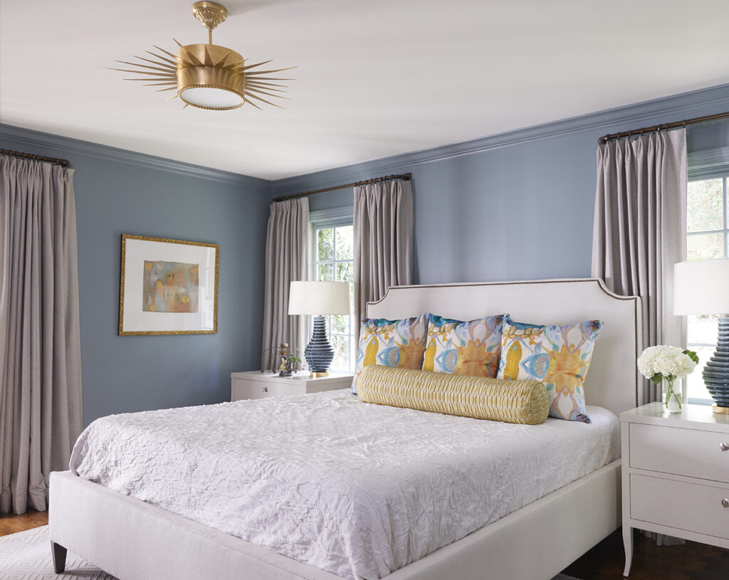 Calming blue walls and pop of gold give this main bedroom a new look.