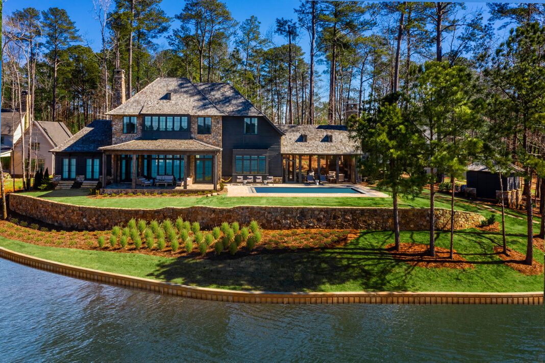 Front elevation of lake house, including a pool.