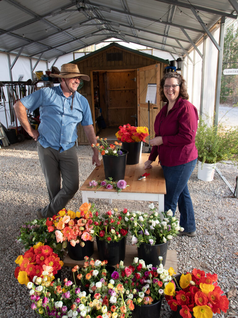 Kirk and Allison Creel prepping buckets of cut flowers.