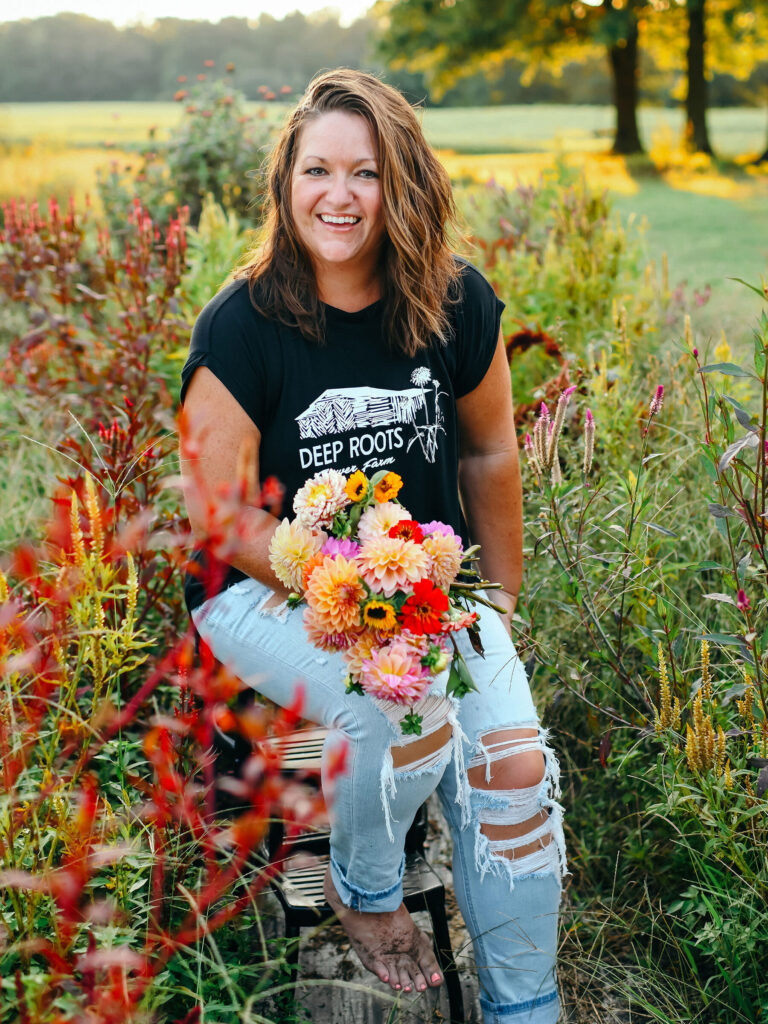 Leah Quarles sitting in floral field with bouquet