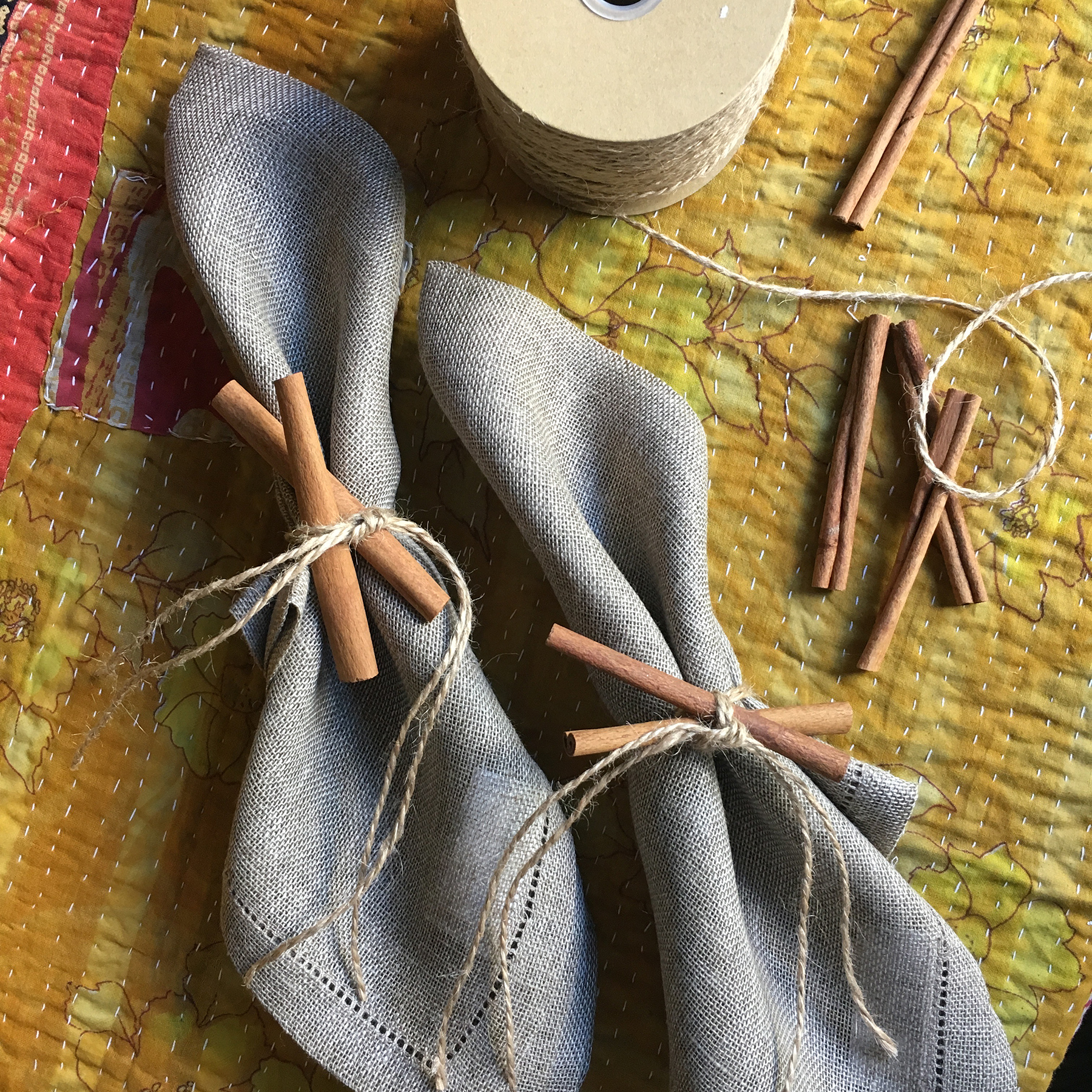 Cinnamon sticks tied around fabric napkins