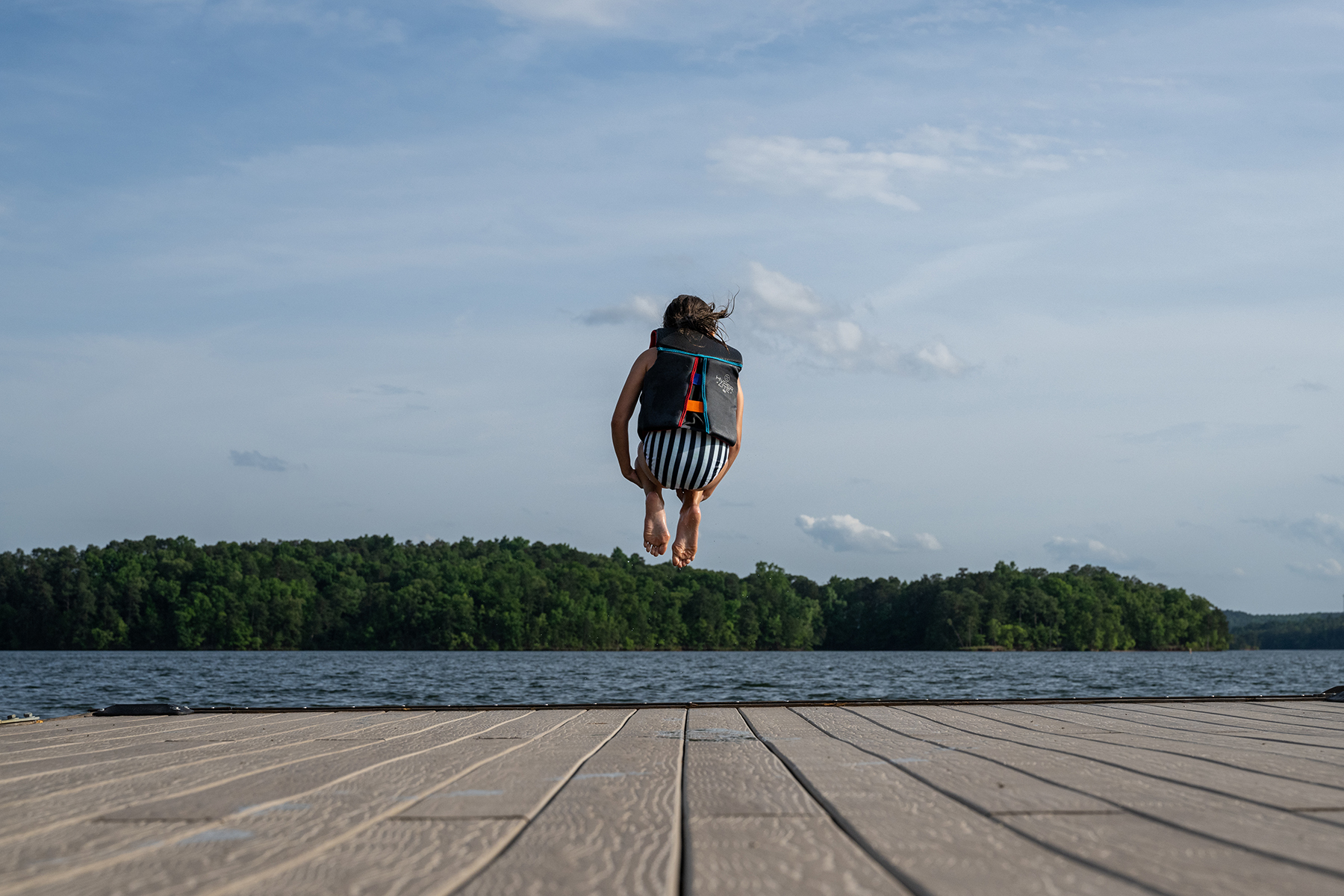 Child jumping into Lake Martin