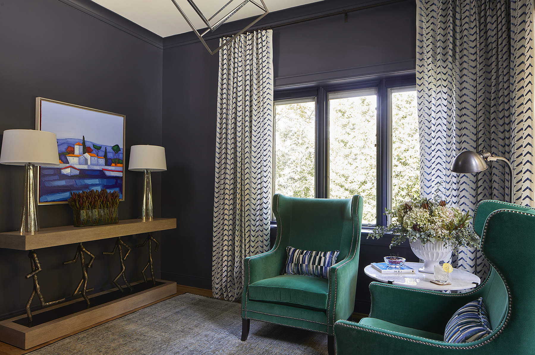Dark walls in the sitting room let the brighter colors of the furniture and art pop.