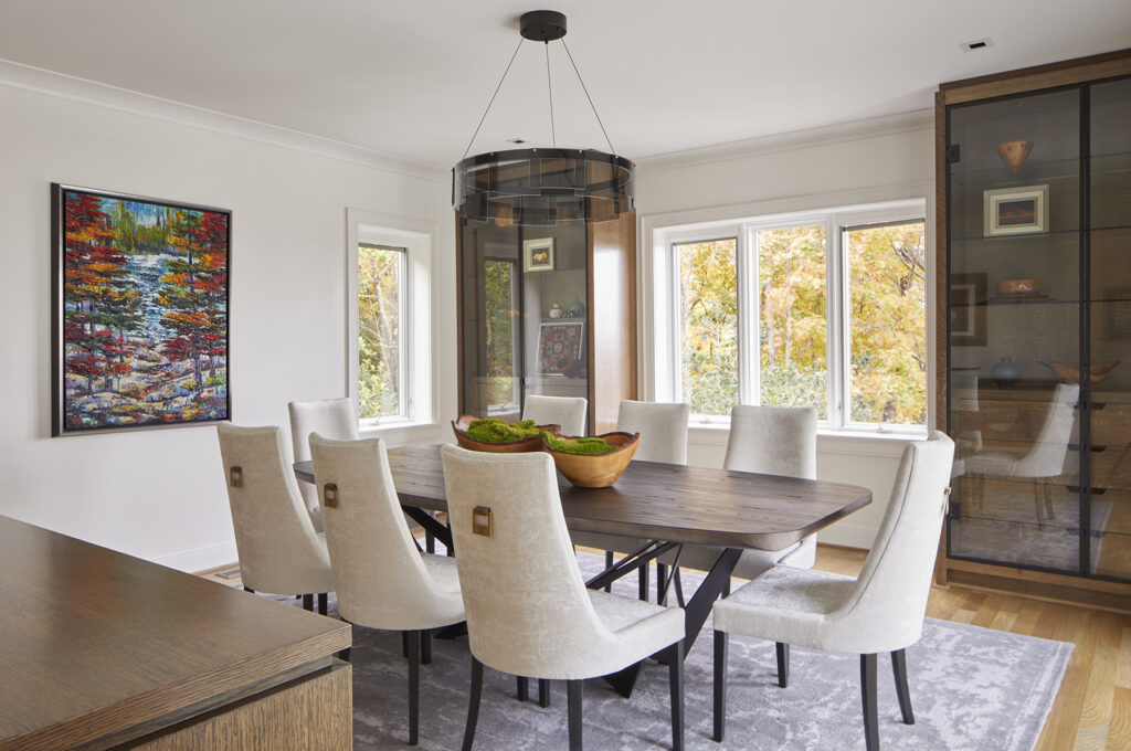 The dining room is filled with simple and elegant furniture pieces that keep the attention on the art in the room.