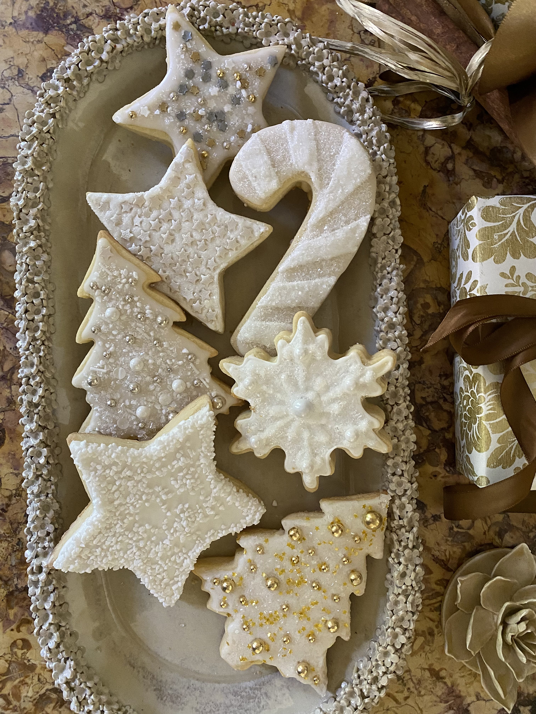 Tray of white decorated sugar cookies.