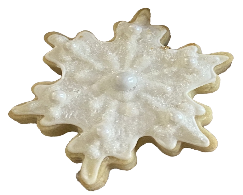 Snowflake shaped sugar cookie with iridescent white icing and sprinkles