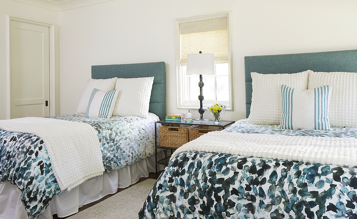 The bedroom in the backyard guest house with two full-size beds. West Elm headboards and pretty printed coverlets. 
